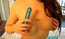 Voluptuous brown-haired hoe sticks blue dildo in her pussy